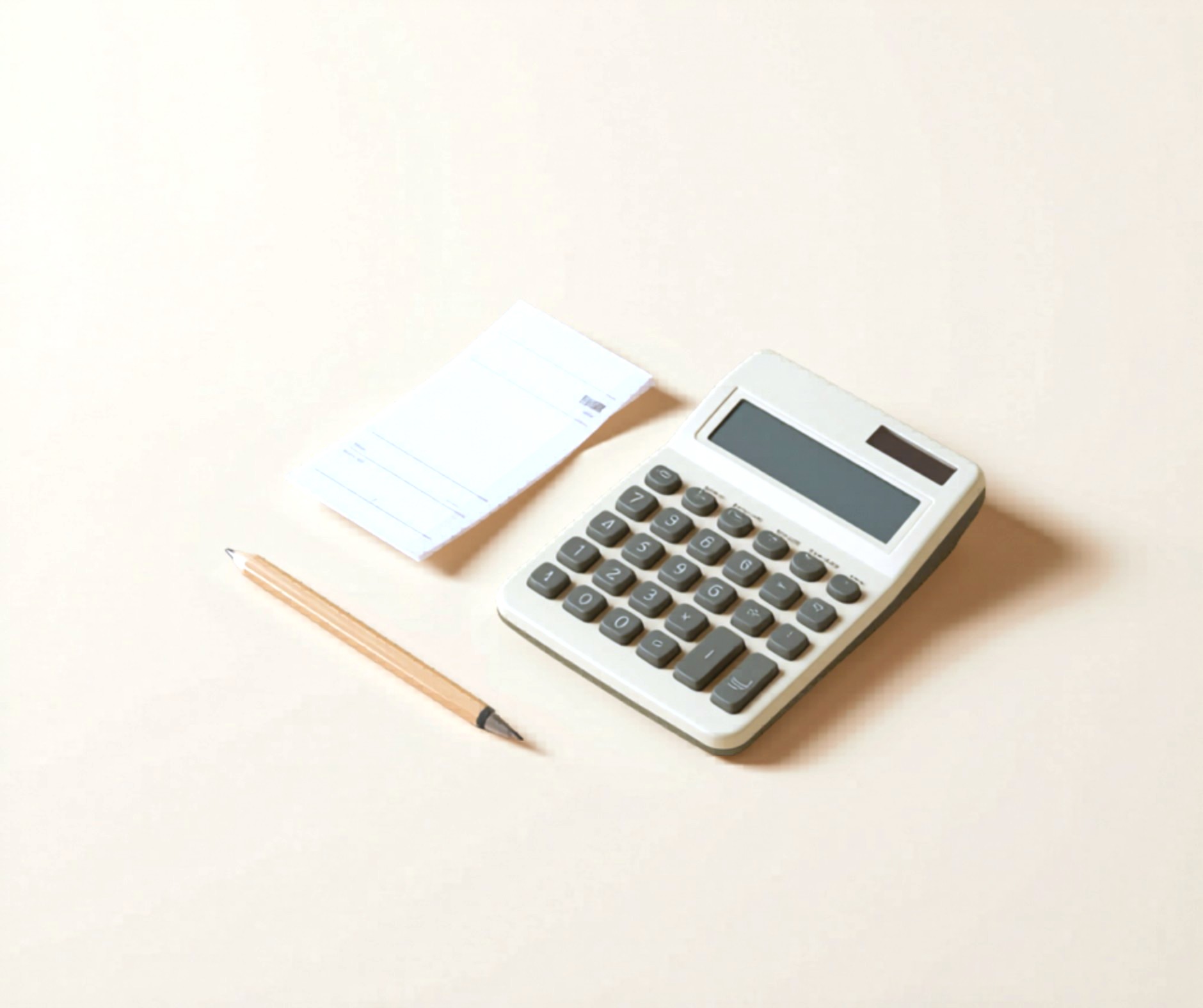 A desktop calculator, paystub, and pencil on a plain cream background